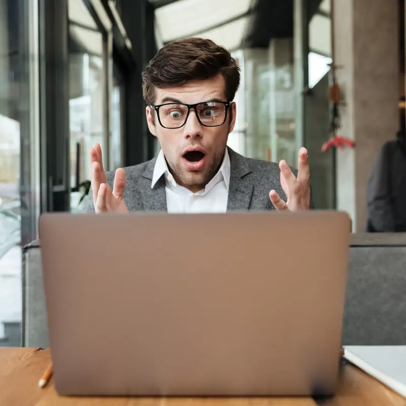 Shocked Businessman Eyeglasses Sitting By Table Cafe Looking Laptop Computer