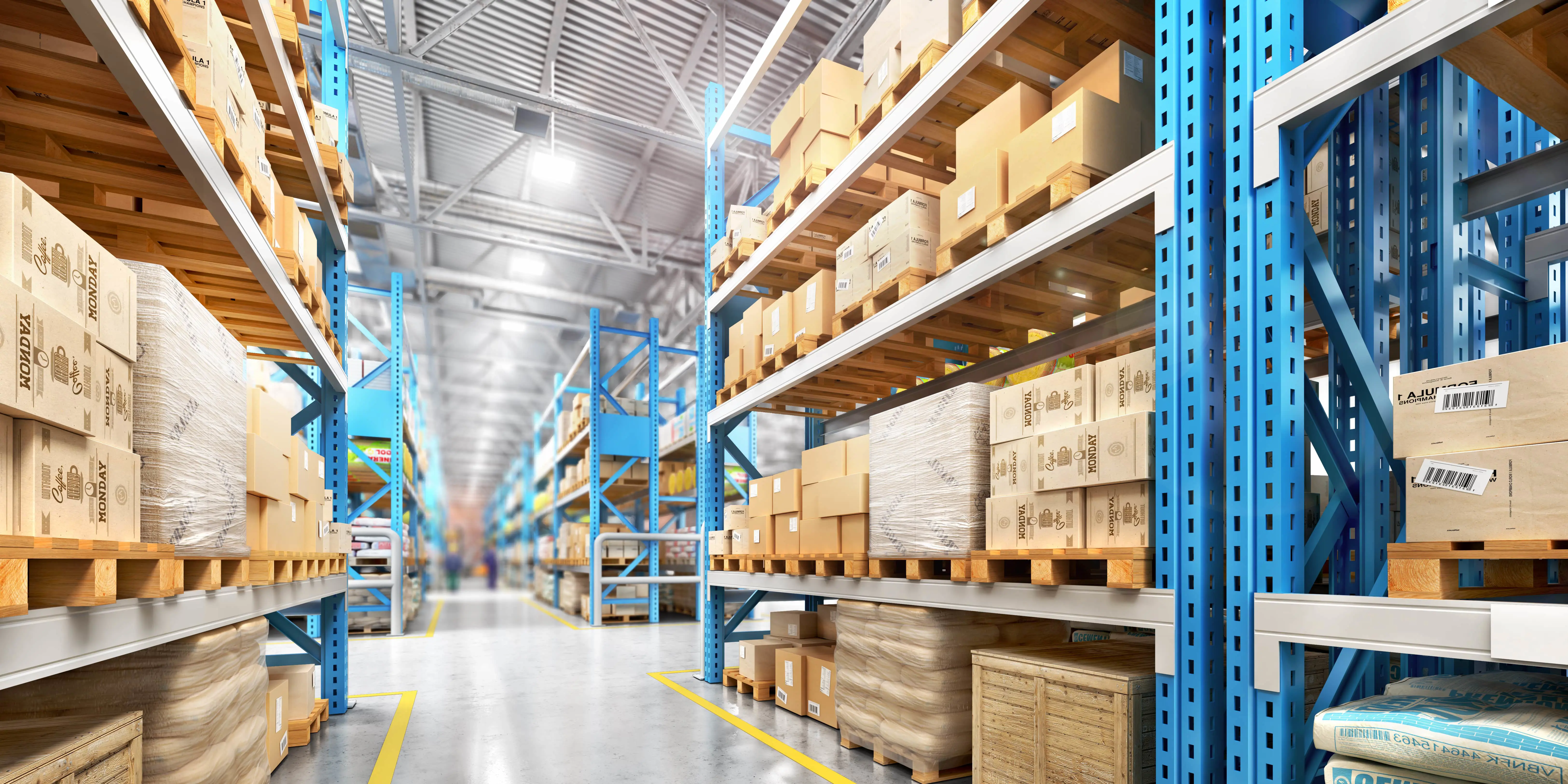 A fully stock warehouse with multiple boxes and stacks of shelves with no people around